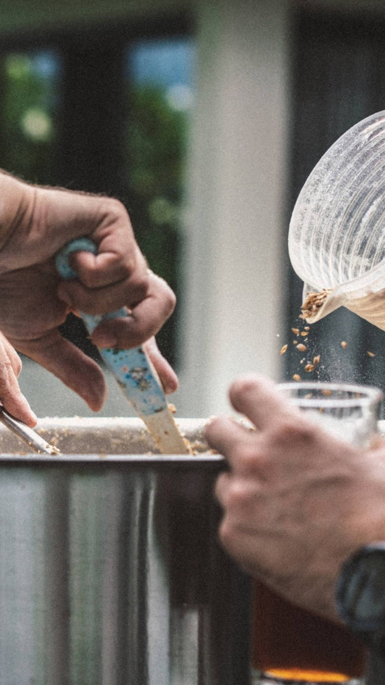 Pouring and stirring grain to make wort